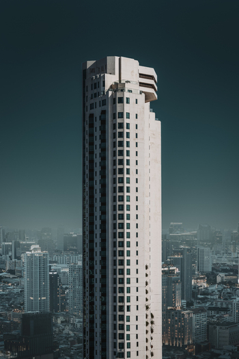 View of modern skyscrapers and urban landscape at night with city lights Bangkok Thailand.