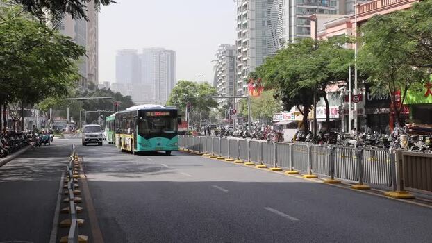 View of a city street with a bus in Shenzhen China. View of a city street with a bus in Shenzhen China.