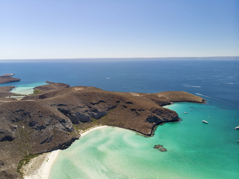 Aerial view of Balandra beach with its turquoise waters white sand and rocky hills under a clear blue sky in La Paz Baja California Sur Mexico. Aerial view of Balandra beach with its turquoise waters white sand and rocky hills under a clear blue sky in La Paz Baja California Sur Mexico.