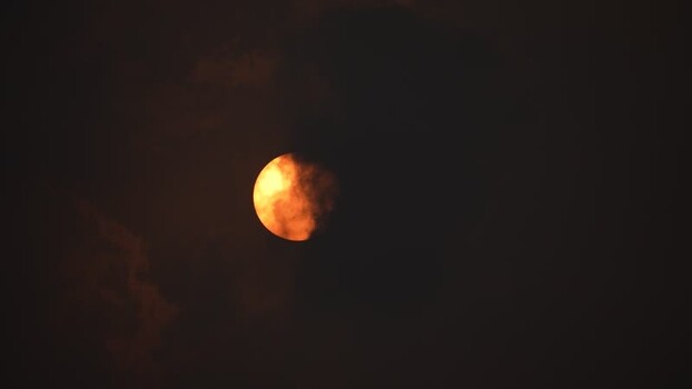 View of the sun behind dark clouds Bangladesh.