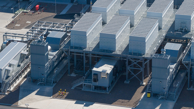 Aerial view of Datacenter Westpoort featuring cooling units metal structures and solar panels on a clear day in Groningen Groningen Netherlands. Aerial view of Datacenter Westpoort featuring cooling units metal structures and solar panels on a clear day in Groningen Groningen Netherlands.