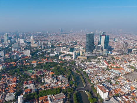Surabaya East Java Indonesia 29 August 2026 Aerial view of Surabaya city with high rise buildings a winding river and dense residential rooftops under a clear blue sky. Surabaya East Java Indonesia 29 August 2026 Aerial view of Surabaya city with high rise buildings a winding river and dense residential rooftops under a clear blue sky.