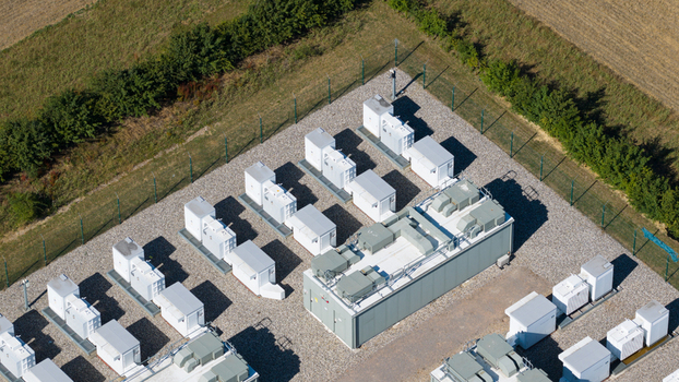 Aerial view of the Pelham Storage Limited battery energy storage facility with rows of white containers on a gravel lot in Bishop s Stortford England United Kingdom. Aerial view of the Pelham Storage Limited battery energy storage facility with rows of white containers on a gravel lot in Bishop s Stortford England United Kingdom.