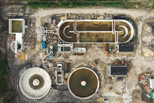 Diepenbeek Belgium 30 August 2026 Aerial view of the wastewater treatment plant featuring circular sedimentation tanks and aeration basins under construction in an industrial setting. Diepenbeek Belgium 30 August 2026 Aerial view of the wastewater treatment plant featuring circular sedimentation tanks and aeration basins under construction in an industrial setting.