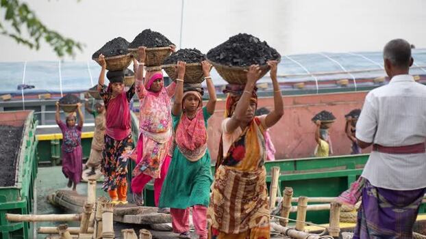 View of women carrying coal baskets at Aminbazar Bangladesh.