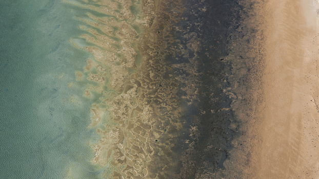 Aerial view of the turquoise blue water and intricate sand patterns along the coastline in Denham Western Australia Australia. Aerial view of the turquoise blue water and intricate sand patterns along the coastline in Denham Western Australia Australia.