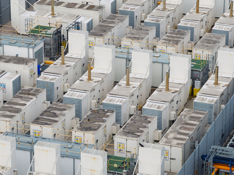 Aerial view of a data center with rows of industrial cooling units and power infrastructure in the United Kingdom.
