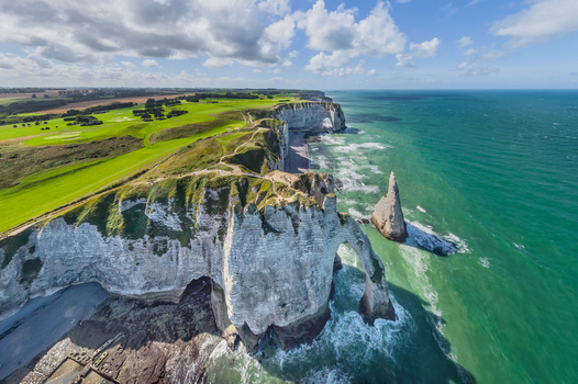 Aerial view of dramatic chalk cliffs meeting the turquoise sea &Eacute;tretat France.