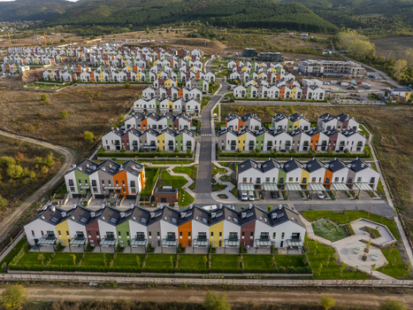 Aerial view of Residential Park Lozen featuring modern colorful townhouses with green lawns and paved walkways in Sofia Sofia City Province Bulgaria. Aerial view of Residential Park Lozen featuring modern colorful townhouses with green lawns and paved walkways in Sofia Sofia City Province Bulgaria.