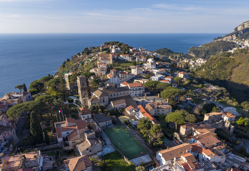 Aerial view of a coastal village with terracotta rooftops cascading down the hillside towards the azure sea Ravello Campania Italy. Aerial view of a coastal village with terracotta rooftops cascading down the hillside towards the azure sea Ravello Campania Italy.