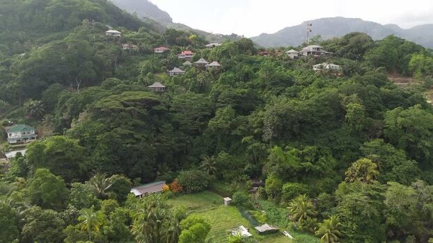 Aerial view of lush hills and houses in Mahe Seychelles.