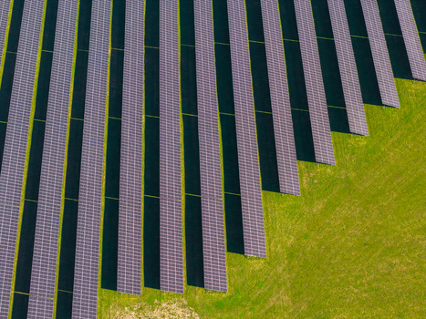 Aerial view of rows of solar panels installed in a green field showcasing sustainable energy infrastructure in Pomeranian Voivodeship Poland. Aerial view of rows of solar panels installed in a green field showcasing sustainable energy infrastructure in Pomeranian Voivodeship Poland.