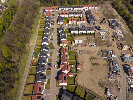 Linlithgow United Kingdom 29 April 2026 Aerial view of a modern residential housing development with rows of houses featuring solar panels and construction sites. Linlithgow United Kingdom 29 April 2026 Aerial view of a modern residential housing development with rows of houses featuring solar panels and construction sites.