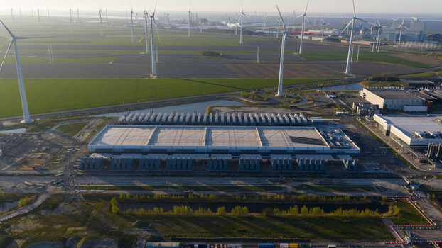 Drone view of a hyperscale data center in Eemshaven showing cloud computing server infrastructure cooling systems backup power and digital connectivity. Drone view of a hyperscale data center in Eemshaven showing cloud computing server infrastructure cooling systems backup power and digital connectivity.
