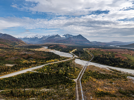 Aerial view of the Delta River winding through the autumn landscape with the Trans Alaska Pipeline and Richardson Highway in Southeast Fairbanks Alaska United States. Aerial view of the Delta River winding through the autumn landscape with the Trans Alaska Pipeline and Richardson Highway in Southeast Fairbanks Alaska United States.