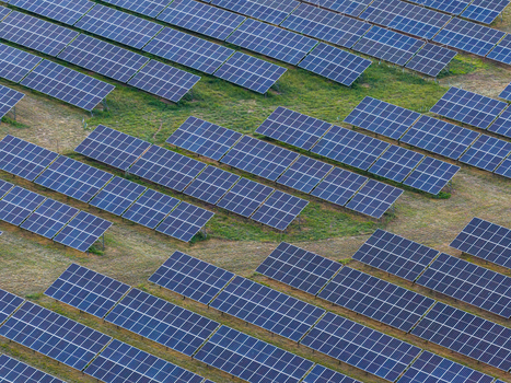 Aerial view of a large solar panel farm with rows of photovoltaic panels installed on green grass in the rural landscape of mazowieckie Poland. Aerial view of a large solar panel farm with rows of photovoltaic panels installed on green grass in the rural landscape of mazowieckie Poland.