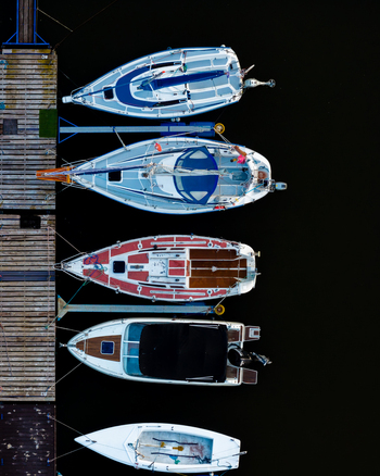 Aerial view of sailboats moored at a wooden pier on the Vistula River in Plock Masovian Voivodeship Poland. Aerial view of sailboats moored at a wooden pier on the Vistula River in Plock Masovian Voivodeship Poland.