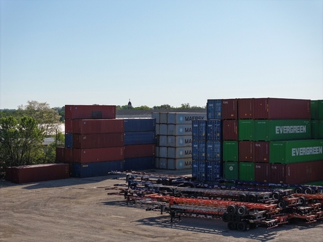 Cincinnati United States 19 April 2026 Aerial view of stacks of colorful shipping containers and rows of chassis trailers in an industrial yard under a clear blue sky.