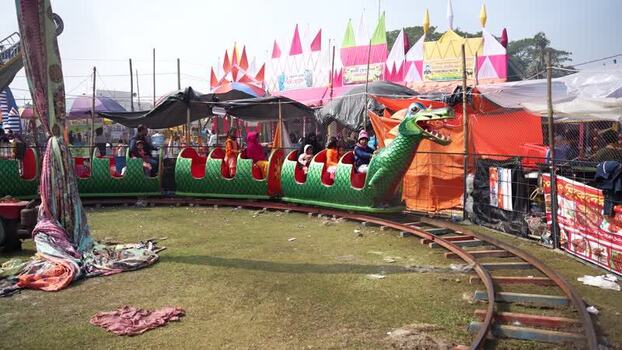 View of a dragon themed carnival train ride Bangladesh. View of a dragon themed carnival train ride Bangladesh.