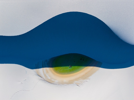 Aerial view of the Parque Nacional dos Lencois Maranhenses with a vibrant green lagoon nestled between white sand dunes and a person swimming in Lencois Maranhenses MA Brazil. Aerial view of the Parque Nacional dos Lencois Maranhenses with a vibrant green lagoon nestled between white sand dunes and a person swimming in Lencois Maranhenses MA Brazil.