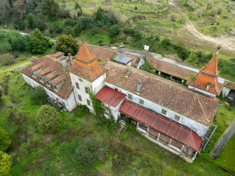 Aerial view of Ruinas Quinta da Zombaria with weathered terracotta rooftops and stone walls Uniao das freguesias de Antuzede e Vil de Matos Coimbra Portugal.