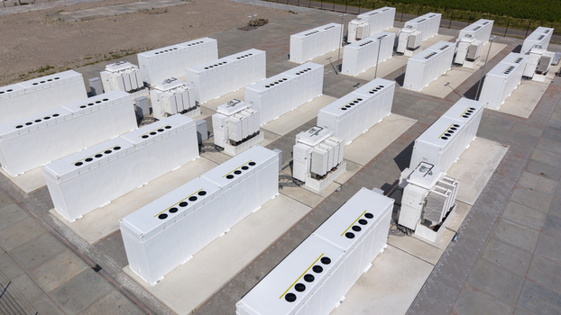 Aerial view of the Battery Energy Storage System at Wind Park with rows of white industrial storage containers arranged on concrete pads in Dronten Flevoland Netherlands. Aerial view of the Battery Energy Storage System at Wind Park with rows of white industrial storage containers arranged on concrete pads in Dronten Flevoland Netherlands.