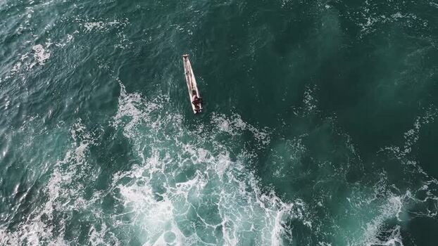 Aerial view of a fisherman in a wooden boat on the sea India. Aerial view of a fisherman in a wooden boat on the sea India.