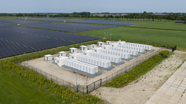 Wanneperveen Netherlands 23 May 2026 Aerial view of a solar farm and battery energy storage system with rows of photovoltaic panels and white containerized units in a field. Wanneperveen Netherlands 23 May 2026 Aerial view of a solar farm and battery energy storage system with rows of photovoltaic panels and white containerized units in a field.