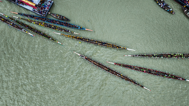 Baghabari Rajshahi Division Bangladesh 20 August 2022 Aerial view of a traditional boat race featuring numerous long narrow boats filled with rowers competing on the river.