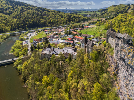 Aerial view of Orava Castle on a high rock cliff overlooking the river and village surrounded by lush green hills Dolny Kubin Zilinsky kraj Slovakia. Aerial view of Orava Castle on a high rock cliff overlooking the river and village surrounded by lush green hills Dolny Kubin Zilinsky kraj Slovakia.