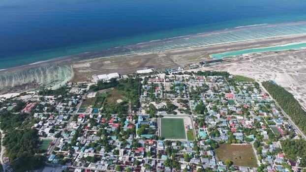 Aerial view of Kudahuvadhoo island and airport Maldives. Aerial view of Kudahuvadhoo island and airport Maldives.