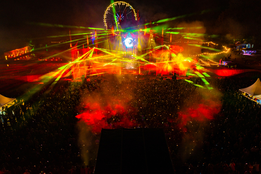 Herzogenaurach Germany 22 July 2022 Aerial view of Open Beatz Festival with vibrant laser lights a Ferris wheel and a large crowd at night. Herzogenaurach Germany 22 July 2022 Aerial view of Open Beatz Festival with vibrant laser lights a Ferris wheel and a large crowd at night.