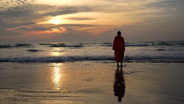 View of a monk standing on Cox s Bazar beach at sunset Bangladesh. View of a monk standing on Cox s Bazar beach at sunset Bangladesh.