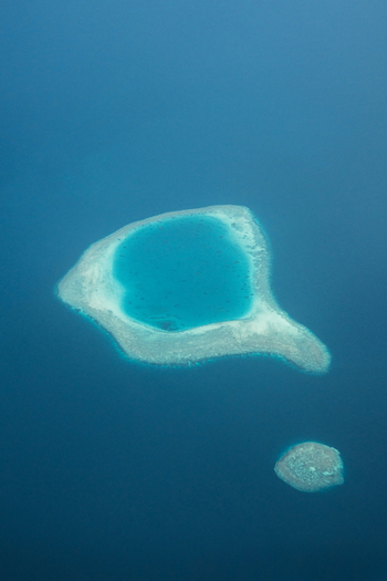 Aerial view of a tranquil island lagoon a jewel of turquoise embraced by the vast cerulean sea Flight from Male to Hanimaadhoo island Maldives.