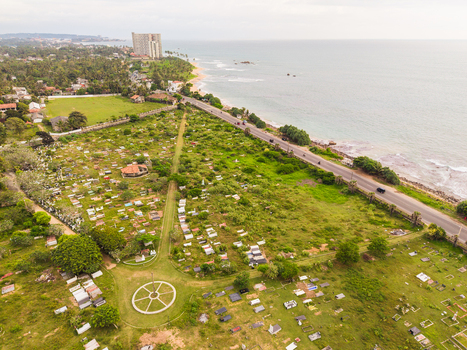 Aerial view of Dadalla Cemetery with white gravestones near the coastline of Dadalla beach and the Indian Ocean in Galle Southern Province Sri Lanka. Aerial view of Dadalla Cemetery with white gravestones near the coastline of Dadalla beach and the Indian Ocean in Galle Southern Province Sri Lanka.