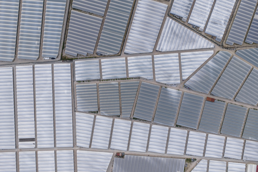 Aerial view of geometric patterns formed by agricultural greenhouses and polytunnels in the countryside of Paestum Campania Italy.