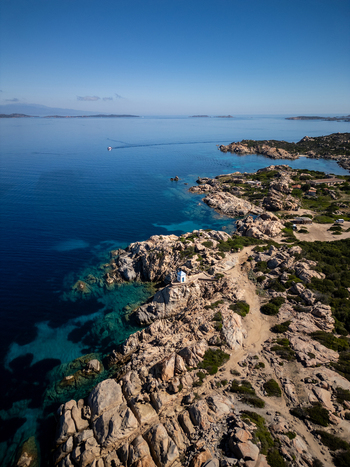 Aerial view of the Altare della Madonnetta chapel perched on a rocky coastline with turquoise water and Mediterranean vegetation in La Maddalena Sardinia Italy. Aerial view of the Altare della Madonnetta chapel perched on a rocky coastline with turquoise water and Mediterranean vegetation in La Maddalena Sardinia Italy.