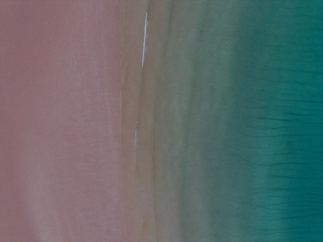 Aerial view of Gruinard Bay featuring pink sand beach meeting turquoise sea water with gentle ripples and abstract textures Gruinard Scotland United Kingdom. Aerial view of Gruinard Bay featuring pink sand beach meeting turquoise sea water with gentle ripples and abstract textures Gruinard Scotland United Kingdom.