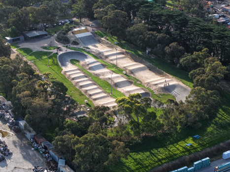 Melbourne VIC Australia 22 September 2026 Aerial view of a BMX dirt track with jumps and berms surrounded by green grass and trees in a park setting. Melbourne VIC Australia 22 September 2026 Aerial view of a BMX dirt track with jumps and berms surrounded by green grass and trees in a park setting.