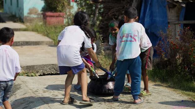 View of children playing with colored powder during a festival Nepal.