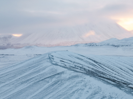 Aerial view of Hverfjall crater covered in deep snow under a soft cloudy sky in Thingeyjarsveit Iceland. Aerial view of Hverfjall crater covered in deep snow under a soft cloudy sky in Thingeyjarsveit Iceland.