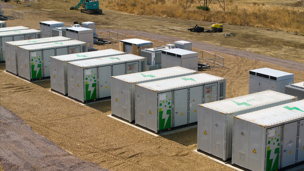 Aerial view of Eaton Socon Substation featuring rows of battery energy storage system containers with green lightning bolt logos on a gravel site in St. Neots England United Kingdom. Aerial view of Eaton Socon Substation featuring rows of battery energy storage system containers with green lightning bolt logos on a gravel site in St. Neots England United Kingdom.