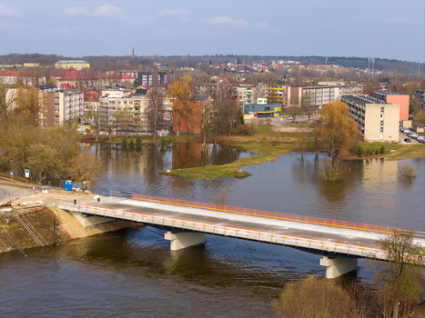 Kedainiai Lithuania 17 March 2026 Aerial view of a modern bridge over the Nevezis river with flooded banks and residential apartment buildings under a clear sky. Kedainiai Lithuania 17 March 2026 Aerial view of a modern bridge over the Nevezis river with flooded banks and residential apartment buildings under a clear sky.