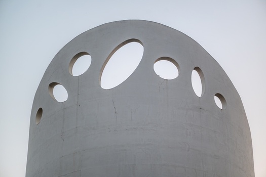 Fatima Santarem Portugal 25 July 2026 Aerial view of the Santissima Trindade Church featuring its distinctive white curved concrete facade with circular openings against a clear sky.