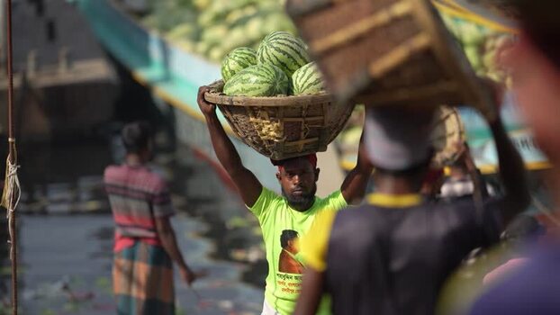 View of workers carrying watermelons at Sadarghat Bangladesh.