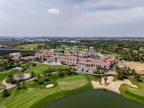 Ahmedabad Gujarat India 21 March 2026 Aerial view of Kalhaar Blues Greens Golf Club with green fairways sand bunkers a water hazard and clubhouse architecture.