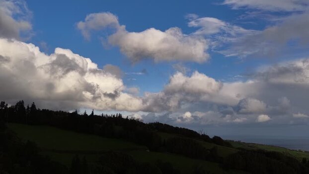 Aerial view of lush green hills and clouds Portugal.
