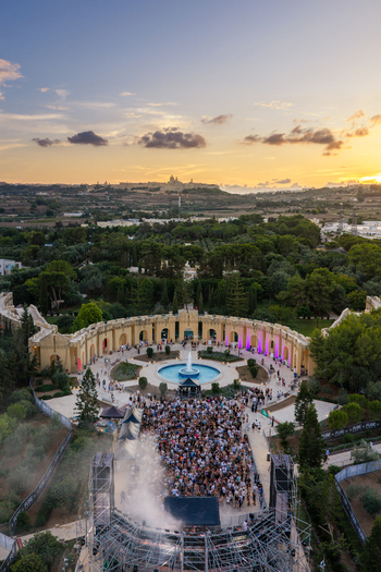 Attard Malta 20 September 2026 Aerial view of a music festival at Park Nazzjonali Ta Qali with a large crowd a central fountain and the historic Mdina skyline at sunset. Attard Malta 20 September 2026 Aerial view of a music festival at Park Nazzjonali Ta Qali with a large crowd a central fountain and the historic Mdina skyline at sunset.