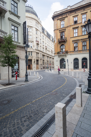 View of the cobblestone Dorottya utca street with historic architecture and Palazzo Dorottya Budapest Hungary.