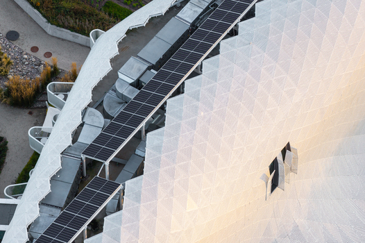 Aerial view of a modern medical resort featuring a white geometric perforated facade and solar panels on the roof in Sopot Pomeranian Voivodeship Poland. Aerial view of a modern medical resort featuring a white geometric perforated facade and solar panels on the roof in Sopot Pomeranian Voivodeship Poland.